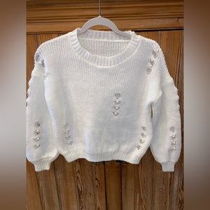 White sweater with wholes and pearls